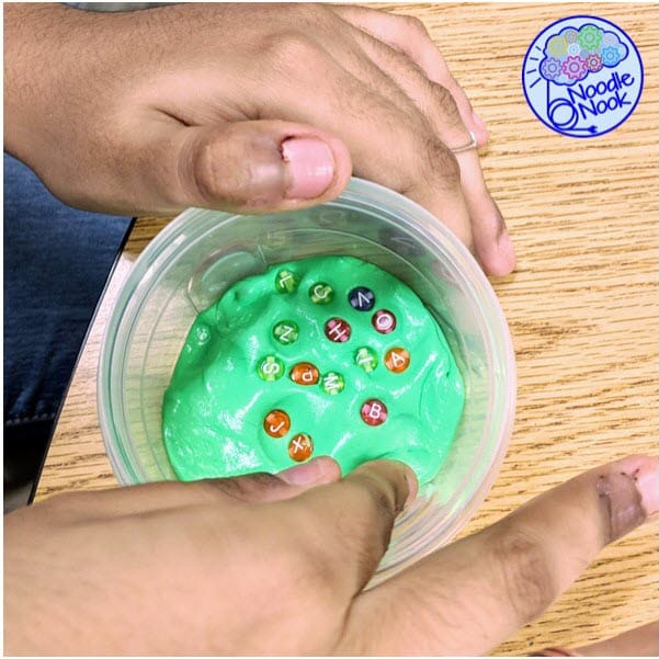 stim toys autism - green therapy putty with letter beads in it.