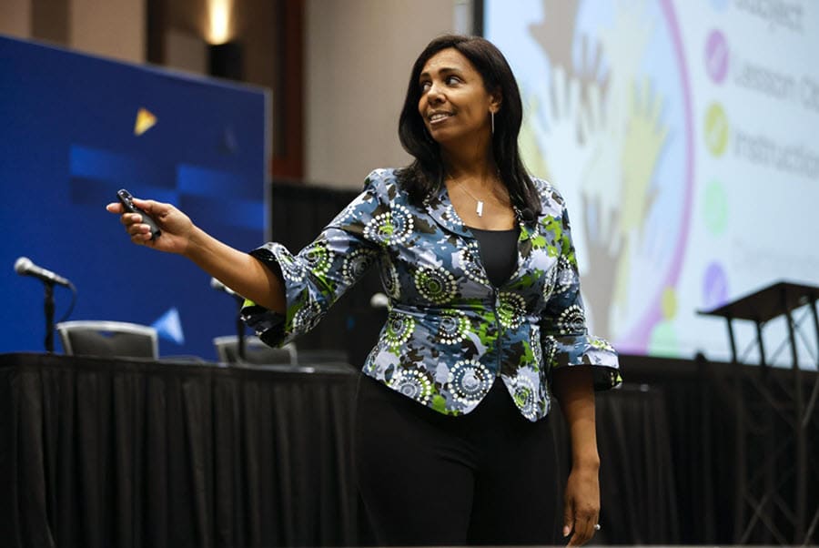 Speaker Ayo Jones presenting to educators at EdTech conference, sharing strategies on AI, access, and inclusion in education.